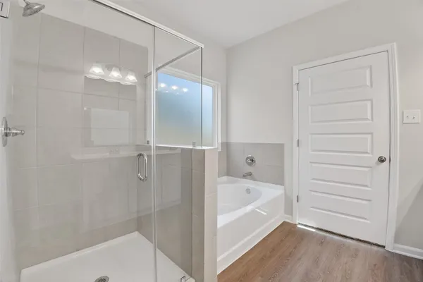 a bathroom with a bathtub and shower