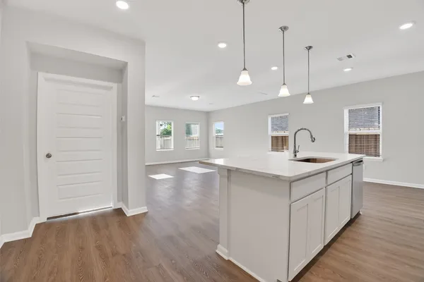 a kitchen with a sink a counter space and a window
