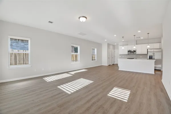 a view of kitchen view with wooden floor and electronic appliances