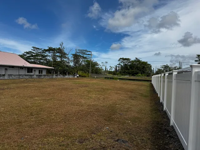 a view of a lake with houses in back