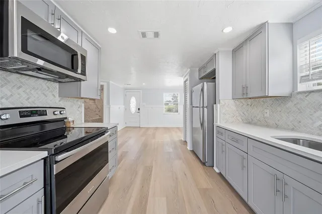 a kitchen with a stove and a microwave
