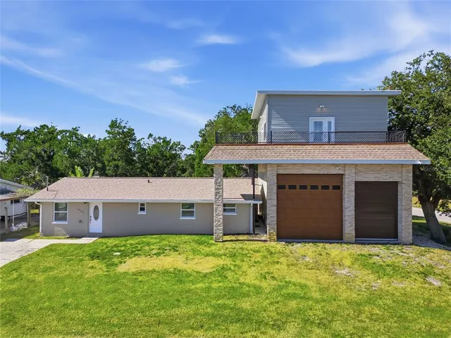 a view of a house with a yard and garage