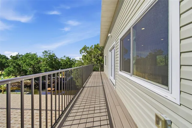 a view of balcony with wooden floor and fence