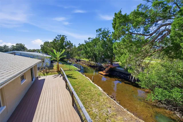 a view of balcony with wooden floor and outdoor seating
