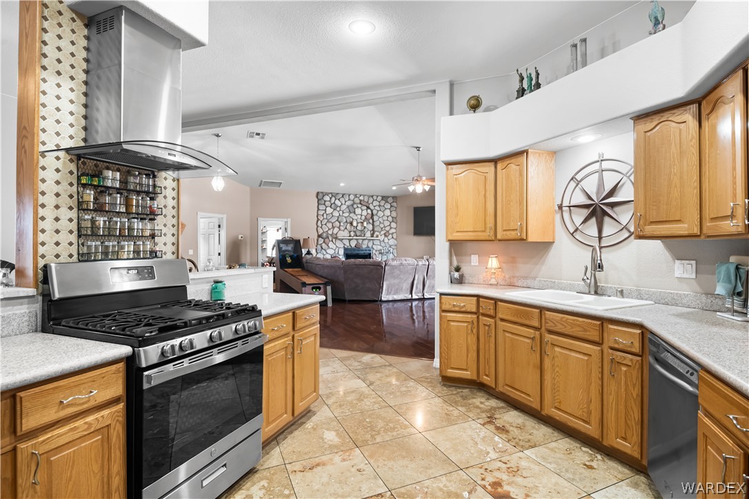 2898 Mountain Trail Road Kingman, AZ 86401 - Photo 74 of 75 a kitchen with stainless steel appliances granite countertop a stove a sink dishwasher and cabinets with wooden floor