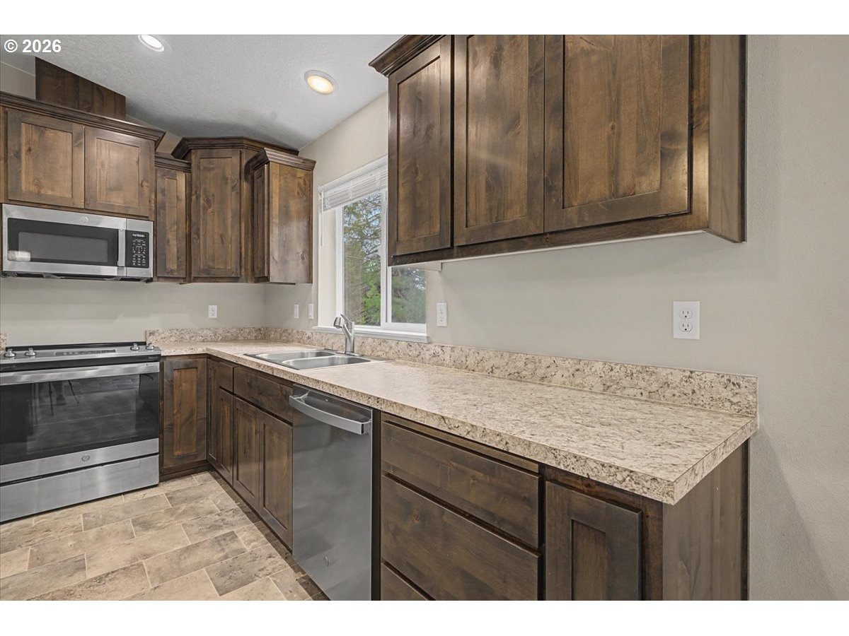 9 North Moolack Way Otis, OR 97368 - Photo 11 of 38 a kitchen with a sink and cabinets