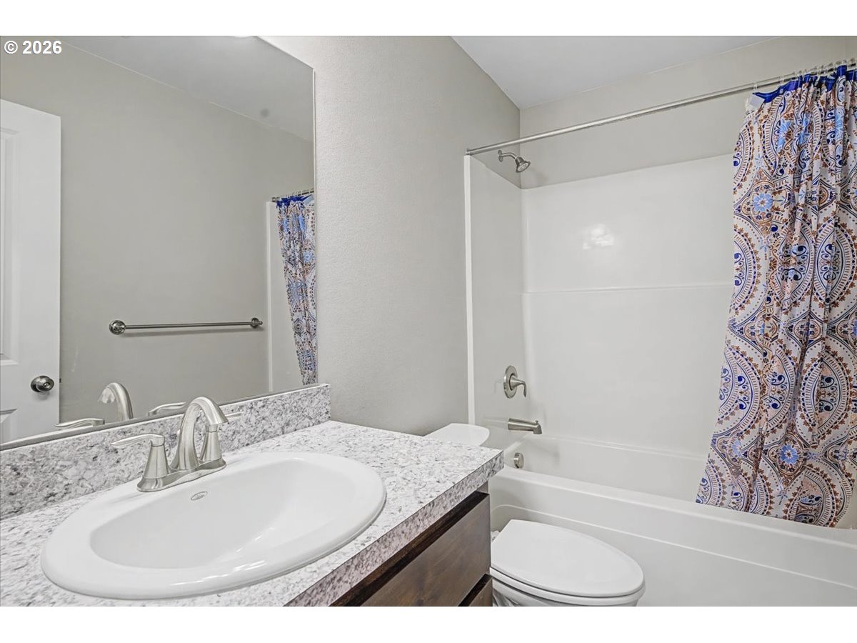 9 North Moolack Way Otis, OR 97368 - Photo 24 of 38 a bathroom with a granite countertop sink a mirror a bathtub and shower