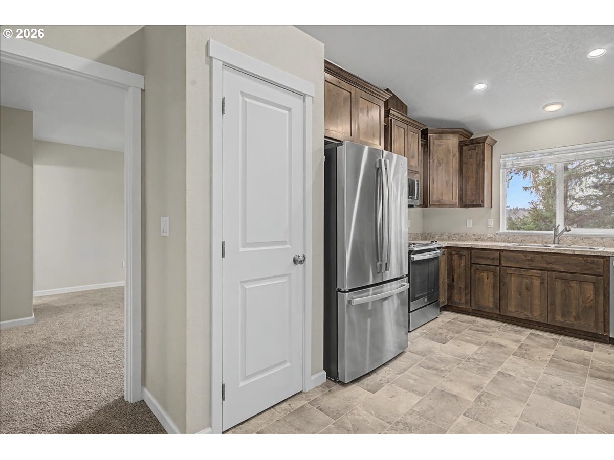 9 North Moolack Way Otis, OR 97368 - Photo 7 of 38 a kitchen with stainless steel appliances a refrigerator and a sink