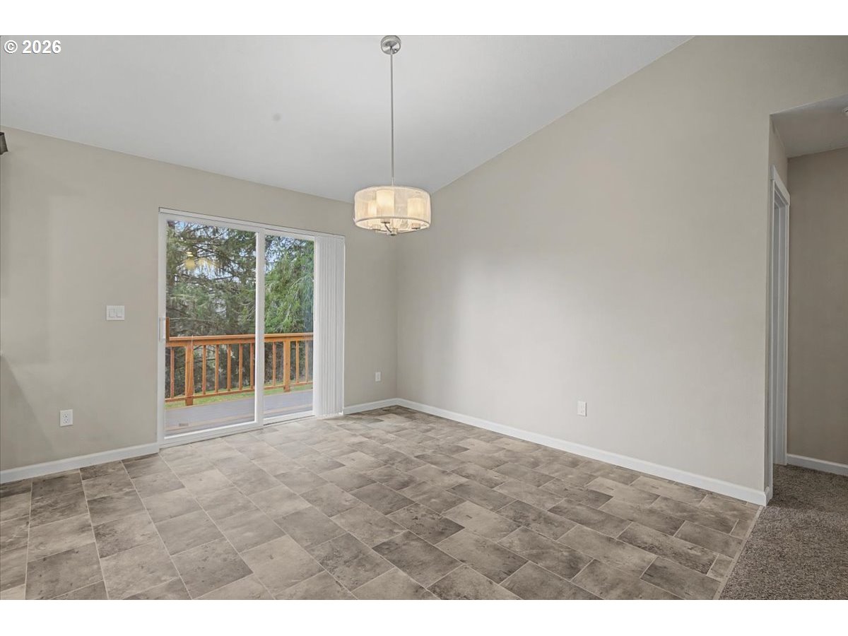 9 North Moolack Way Otis, OR 97368 - Photo 8 of 38 a view of an empty room with wooden floor and a window