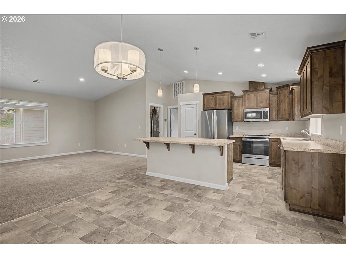 9 North Moolack Way Otis, OR 97368 - Photo 10 of 38 a view of kitchen with cabinets microwave and stove