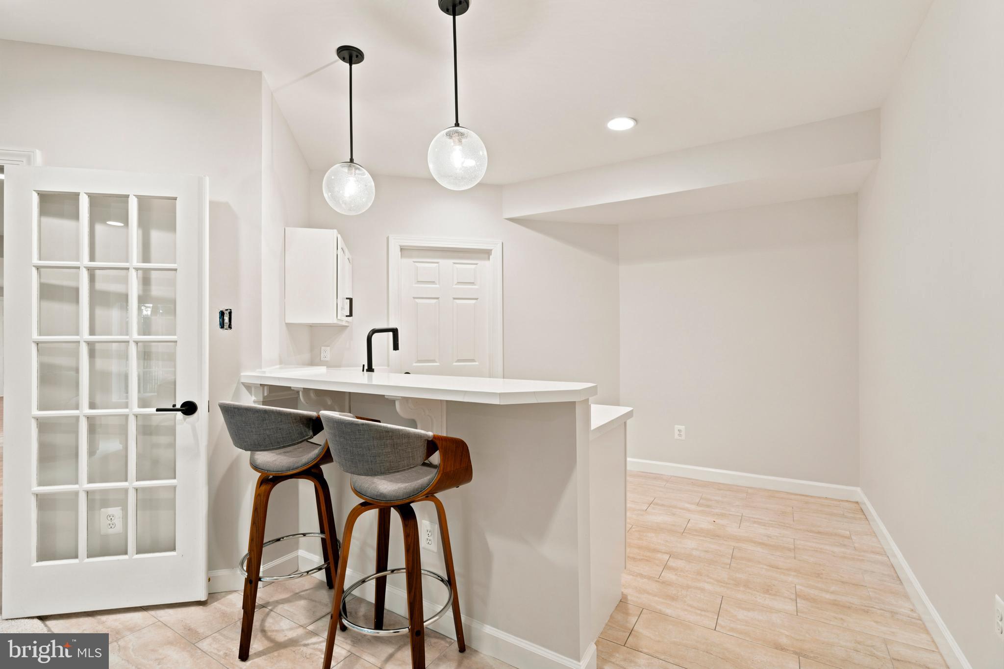 9313 Harrisons Farm Way Laytonsville, MD 20882 - Photo 50 of 77 a view of a kitchen with a sink and chairs