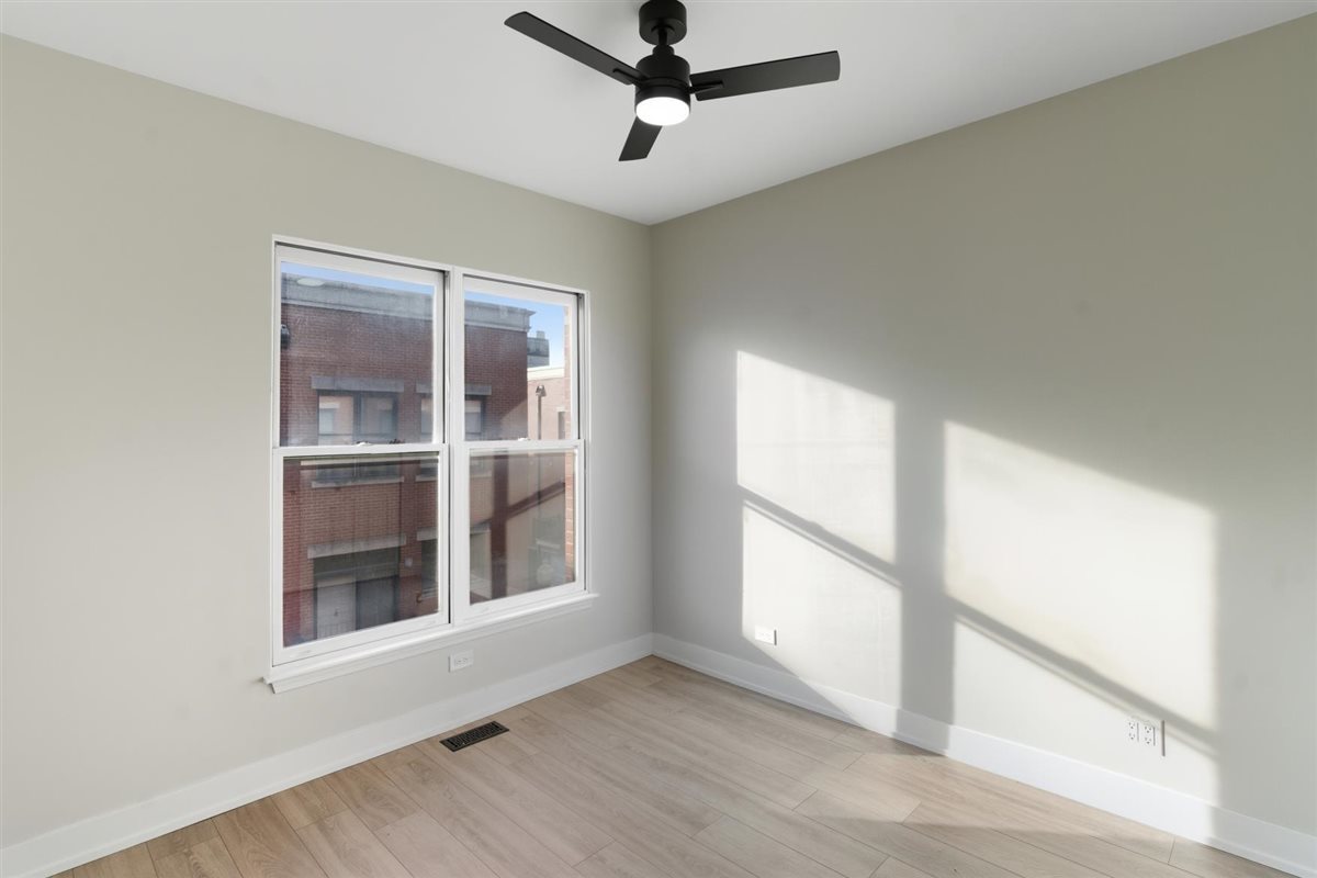 839 West 14th Place Chicago, IL 60608 - Photo 9 of 14 a view of a livingroom with a ceiling fan and window