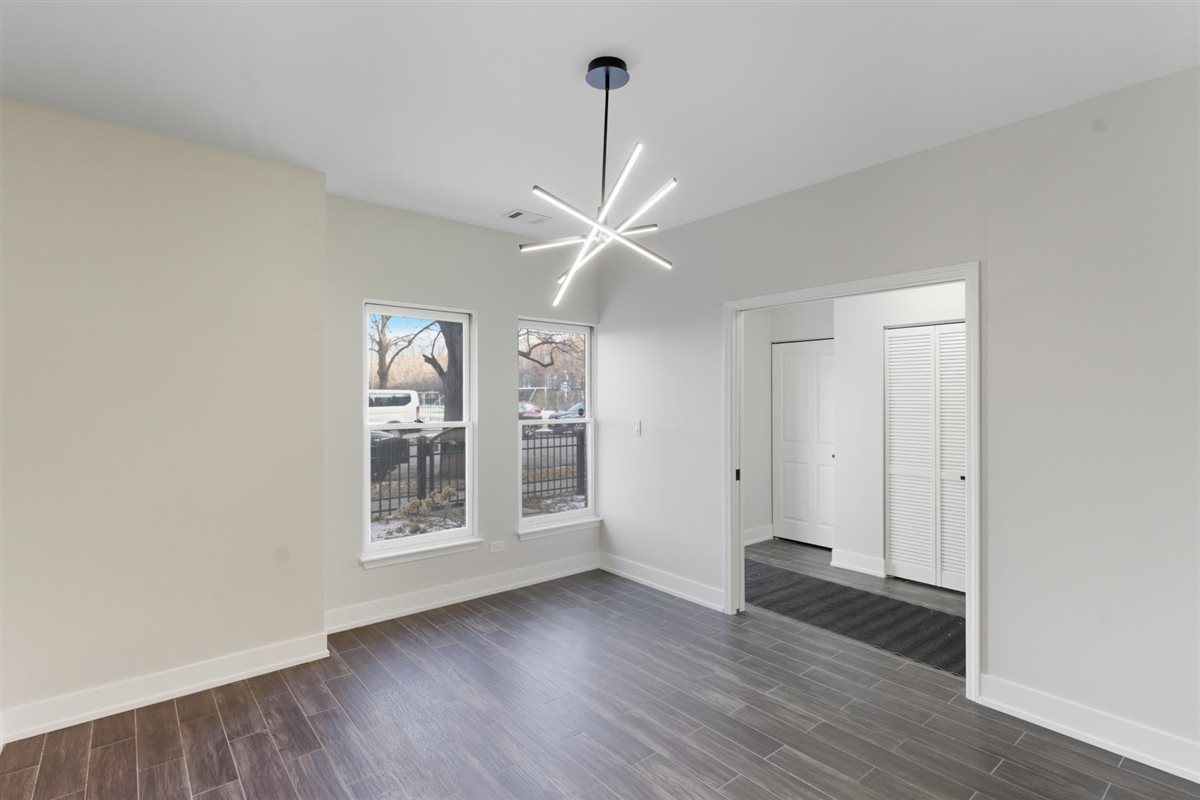 839 West 14th Place Chicago, IL 60608 - Photo 10 of 14 a view of an empty room with a window and wooden floor