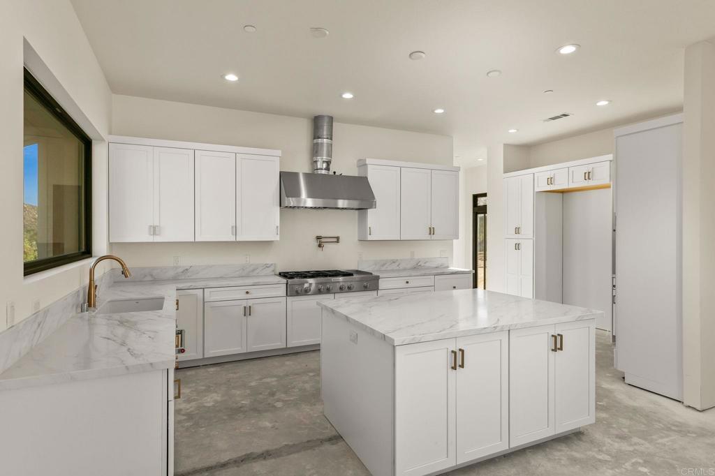 15176 Vali Hai Road Poway, CA 92064 - Photo 16 of 19 a kitchen with a sink stove and cabinets