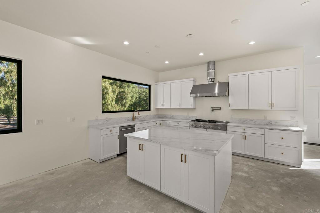 15176 Vali Hai Road Poway, CA 92064 - Photo 10 of 19 a kitchen with white cabinets and sink