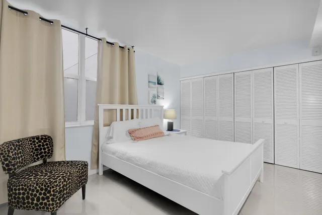 a bedroom with a bed and a night stand