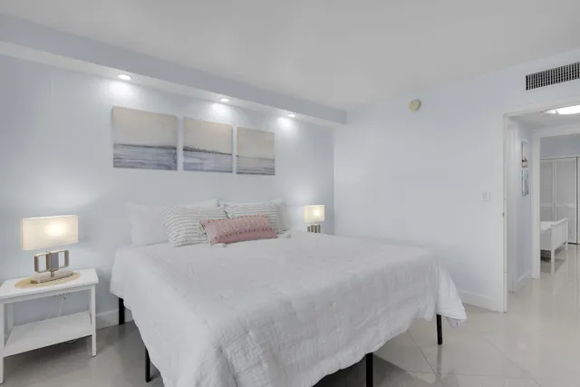 a bedroom with a bed and a white cabinet