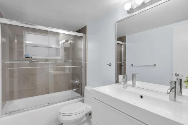 a view of a lake with lawn chairs and a fire pit