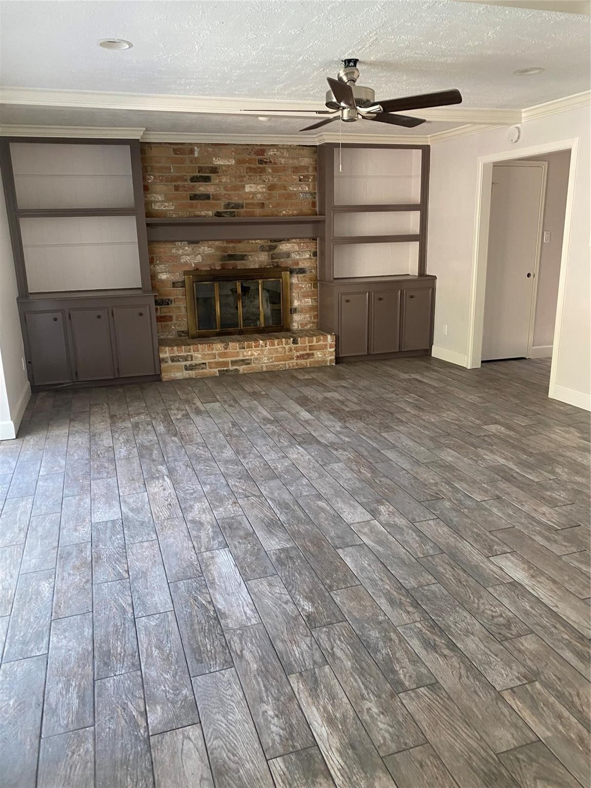 8206 Ash Valley Drive Spring, TX 77379 - Photo 4 of 8 a view of empty room with wooden floor and fireplace