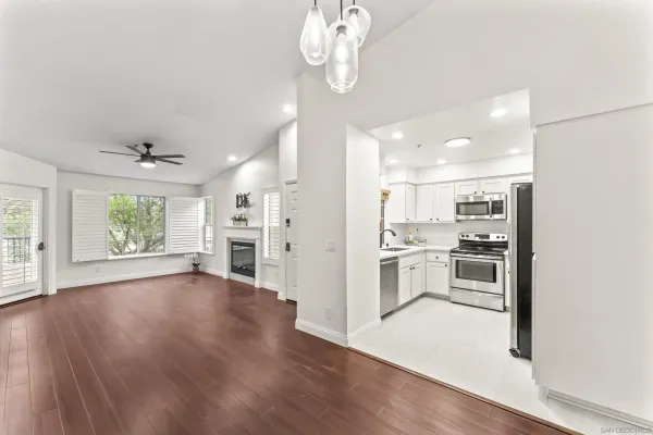 a view of a kitchen with wooden floor and a window
