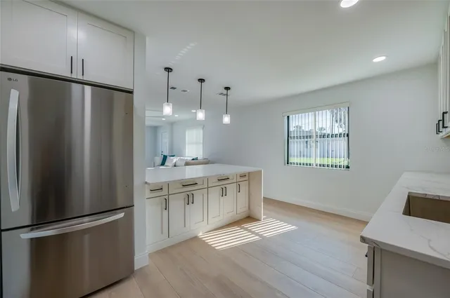 a kitchen with stainless steel appliances a refrigerator and a sink
