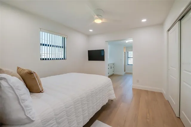 a bedroom with a bed and a large mirror