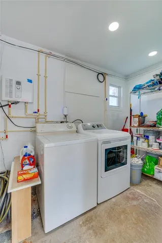 a utility room with sink dryer and washer
