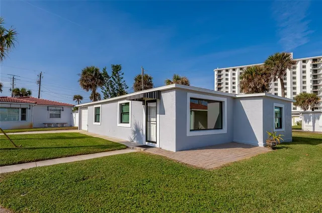 a front view of a house with a garden