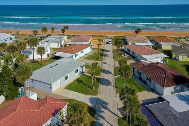swimming pool with outdoor seating and green space