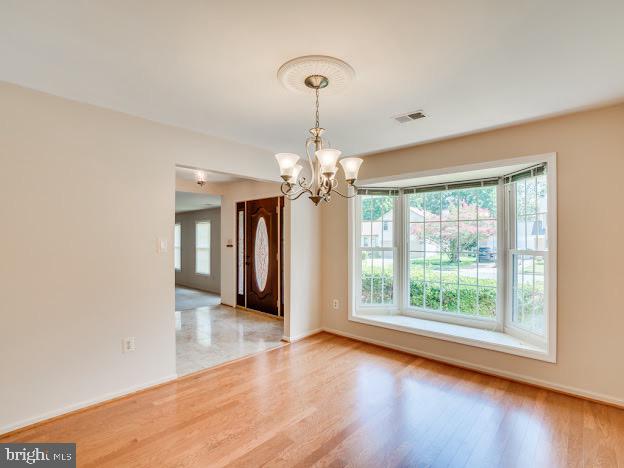 9720 Ironmaster Drive Burke, VA 22015 - Photo 12 of 46 a view of a room with wooden floor chandelier and a window