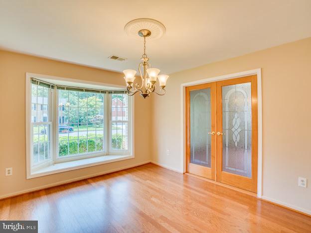 9720 Ironmaster Drive Burke, VA 22015 - Photo 15 of 46 a view of empty room with wooden floor and fan