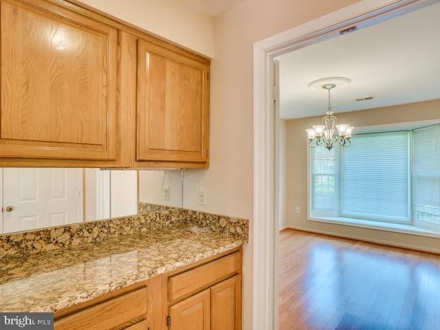 9720 Ironmaster Drive Burke, VA 22015 - Photo 18 of 46 a view of a kitchen with wooden floor and cabinet