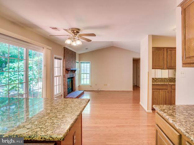 9720 Ironmaster Drive Burke, VA 22015 - Photo 20 of 46 a living room with fireplace furniture and a open kitchen view