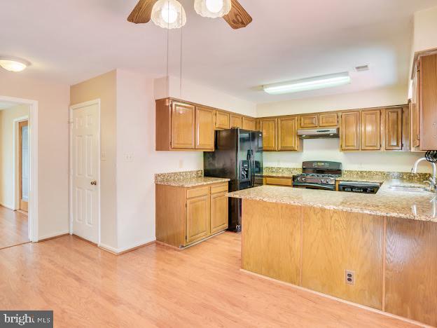 9720 Ironmaster Drive Burke, VA 22015 - Photo 24 of 46 a kitchen with a refrigerator a stove top oven a sink and dishwasher with wooden floor
