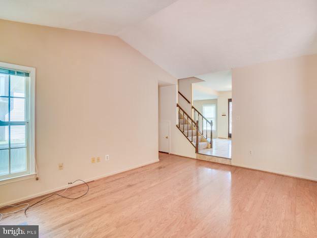 9720 Ironmaster Drive Burke, VA 22015 - Photo 25 of 46 a view of an empty room with wooden floor and windows