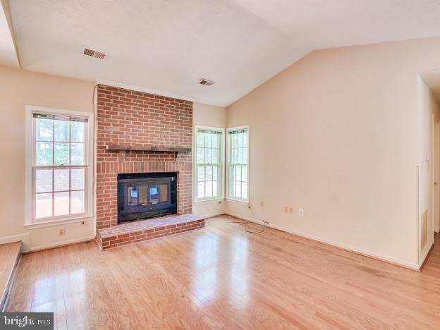 9720 Ironmaster Drive Burke, VA 22015 - Photo 26 of 46 an empty room with wooden floor fireplace and windows