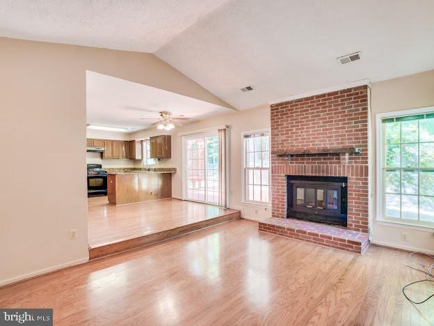 9720 Ironmaster Drive Burke, VA 22015 - Photo 27 of 46 a view of a livingroom with wooden floor a fireplace and window