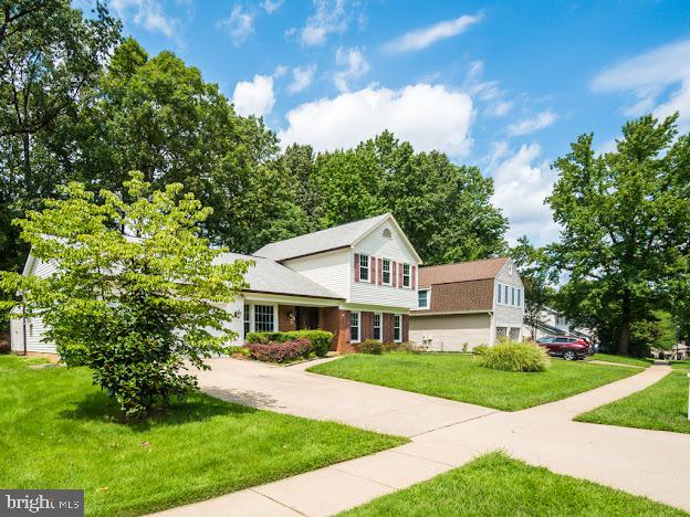 9720 Ironmaster Drive Burke, VA 22015 - Photo 3 of 46 a front view of a house with a yard