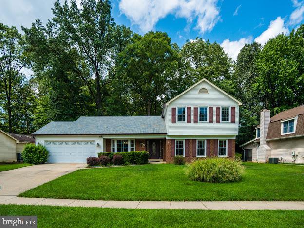 9720 Ironmaster Drive Burke, VA 22015 - Photo 4 of 46 a front view of a house with a yard