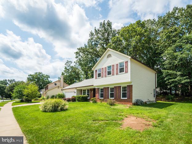 9720 Ironmaster Drive Burke, VA 22015 - Photo 5 of 46 a front view of a house with a garden and porch