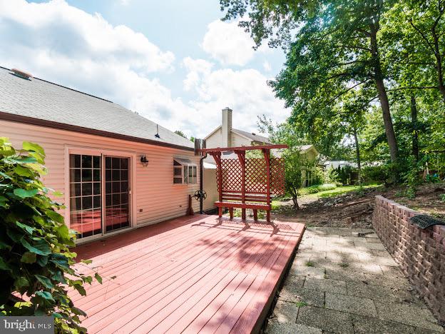 9720 Ironmaster Drive Burke, VA 22015 - Photo 7 of 46 a backyard with table and chairs and potted plants