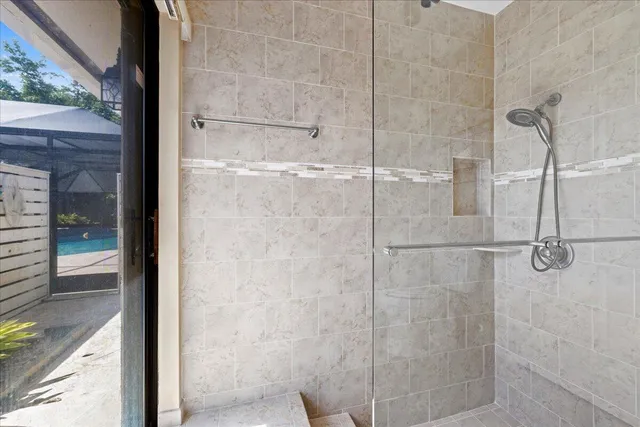 a bathroom with a glass shower door