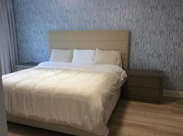 a bed sitting in a bedroom next to a wooden cabinet