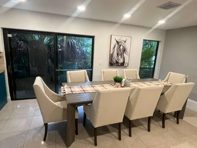 a view of a dining room with furniture large window and outside view