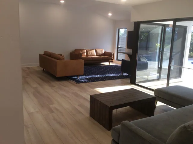 a living room with furniture and a glass door
