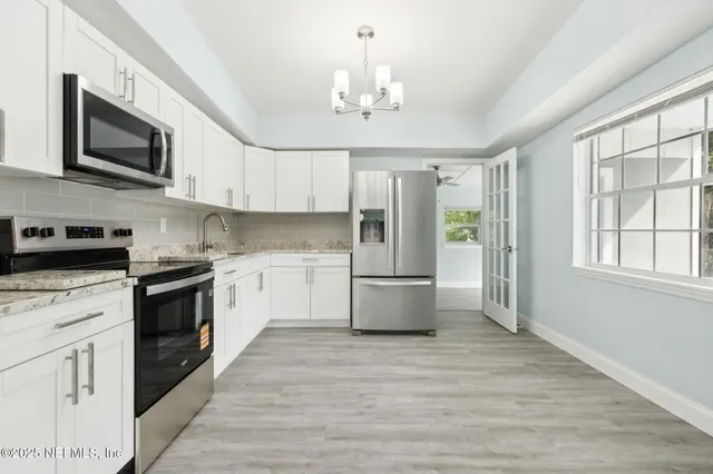 a kitchen with a stove a sink and a refrigerator