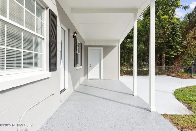 a view of an entryway with a floor to ceiling window and outside view