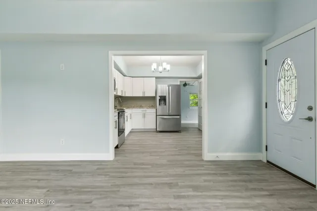 a view of a kitchen with a sink and a refrigerator