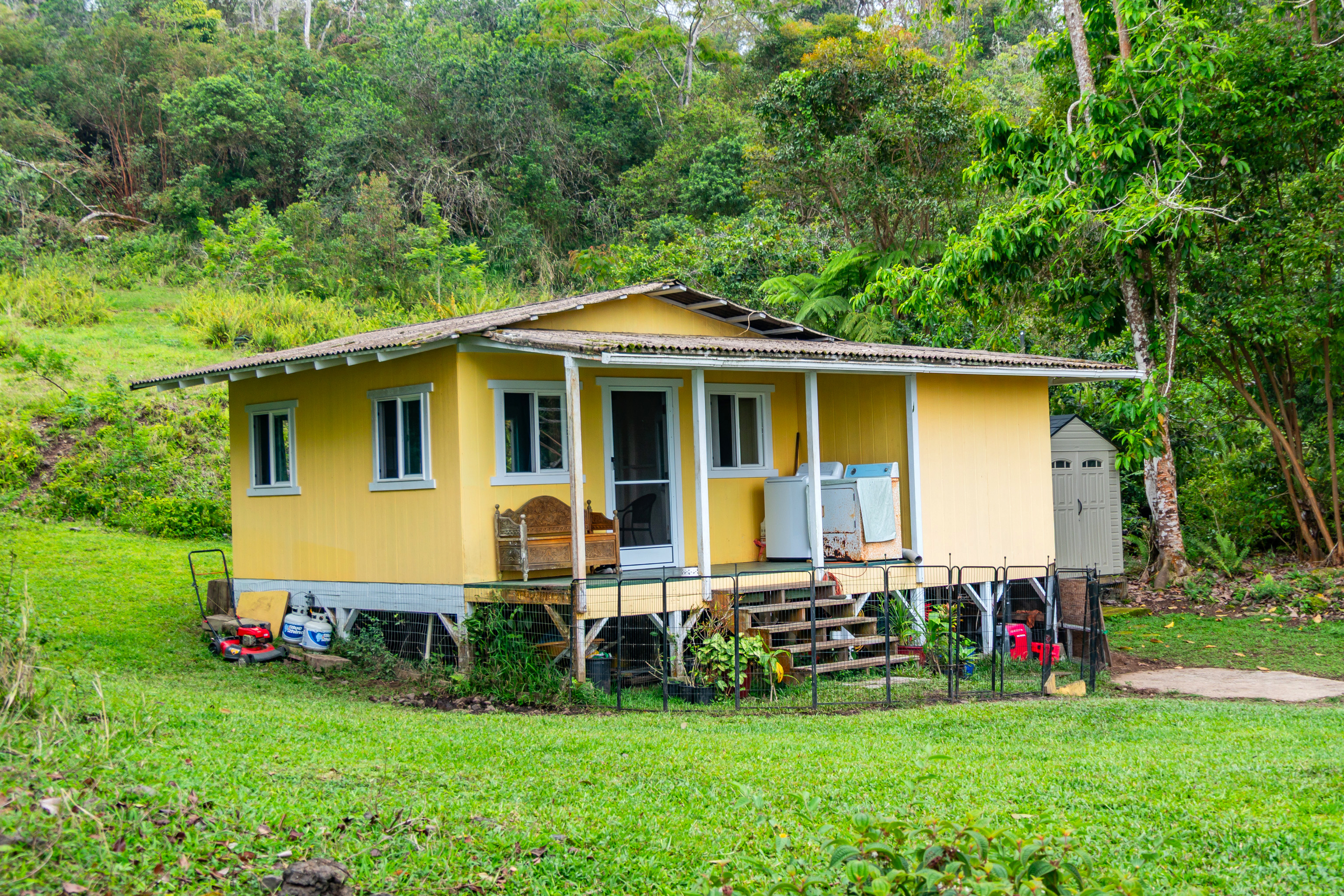 87-1081 Haleili Road Captain Cook, HI 96704 - Photo 6 of 24 a view of a house with a yard and sitting area