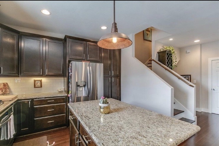 1703 Patterson Street, Unit B Houston, TX 77007 - Photo 4 of 26 a kitchen with stainless steel appliances granite countertop a refrigerator and a stove top oven